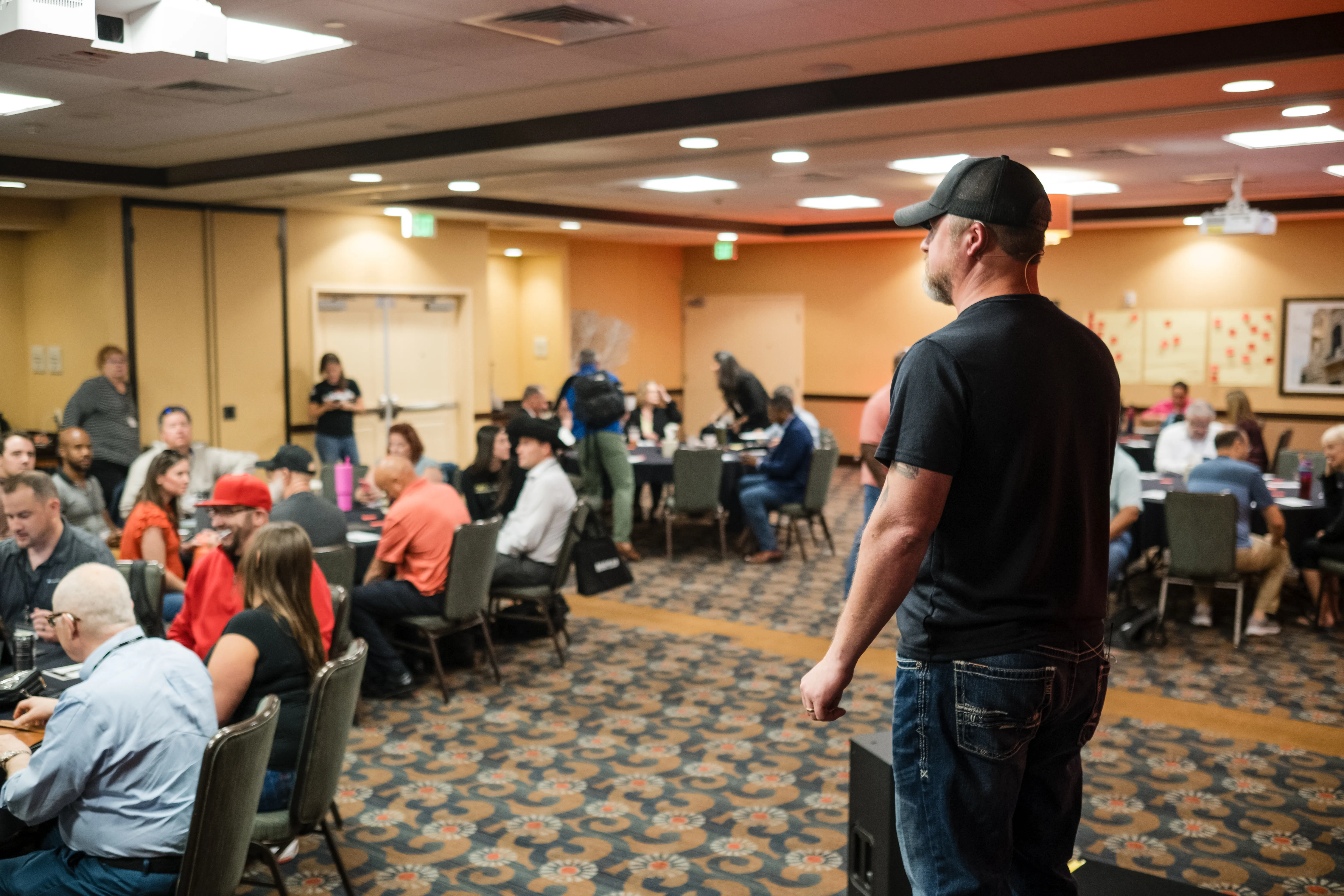 Donnie Boivin on stage in front of a full room